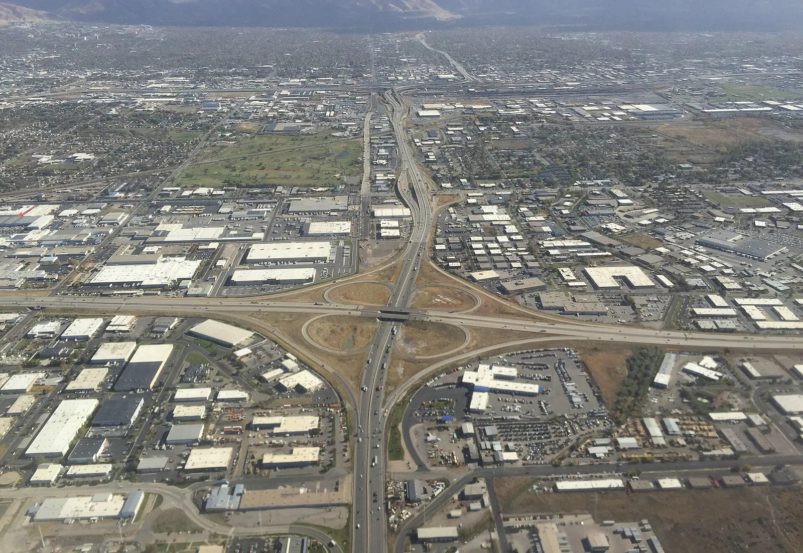 2015-11-03 10 11 29 View east along Utah State Route 201 towards its interchange with Interstate 215 (foreground) and Interstate's 15 and 80 (background) along the border of Salt Lake City and West Valley City, Utah